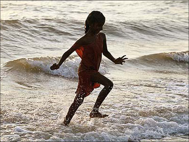 A girl plays at a beach in Chennai, Tamil nadu.