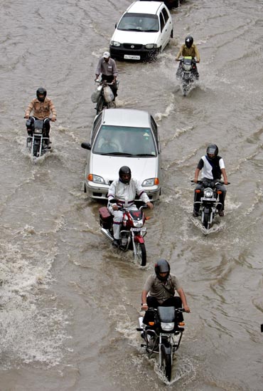 Traffic moves along a flooded road after monsoon rains in New Delhi.