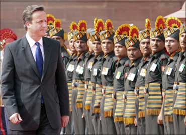 David Cameron inspects a guard of honour during his ceremonial reception at the presidential palace in New Delhi.