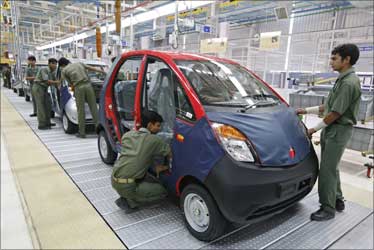 Employees work inside the newly inaugurated plant for the Tata Nano car at Sanand.