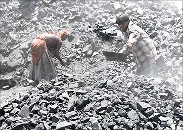 Labourers work at a coal yard on the outskirts of the western Indian city of Ahmedabad.