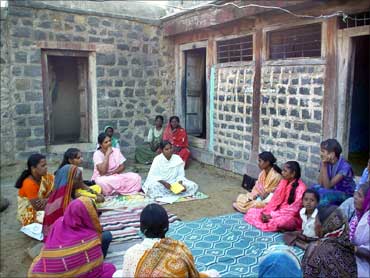 Sinha (seated in a light pink sari) at a self help meeting