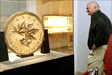 A visitor looks at the world's largest gold coin.