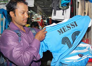 A buyer picks a jersey depicting the Argentinian star footballer Lionel Andres Messi's name.