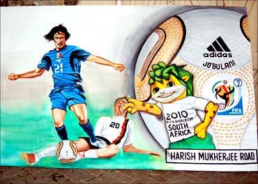Walls are adorned with World Cup-related paintings.