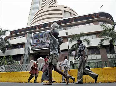 Commuters walk past the Bombay Stock Exchange building in Mumbai.