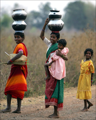 Village women walk barefoot to fetch drinking water in central Chhattisgarh.