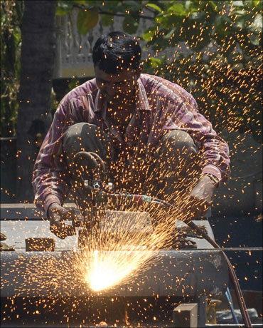 An employee works inside a steel factory.
