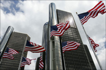 American flags fly in front of General Motors Corp. world headquarters in Detroit, Michigan.
