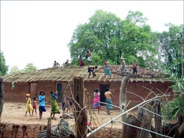Villagers build a house.