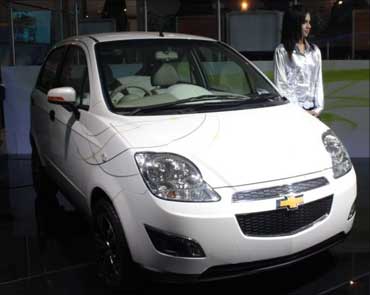 A model poses with Chevrolet E-Spark at the Delhi Auto Show 2010.
