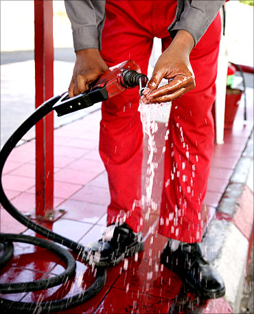 A station attendant washes his hand with gasoline at petrol station in Jeddah.