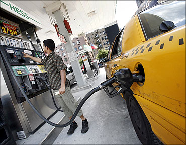 A New York cab driver fills his taxi up with gas at a Hess station.