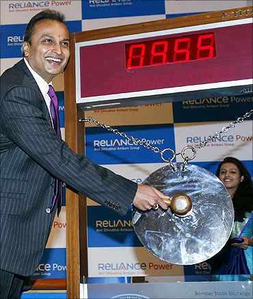 Anil Ambani strikes a gong during the listing of Reliance Power at the Bombay Stock Exchange.