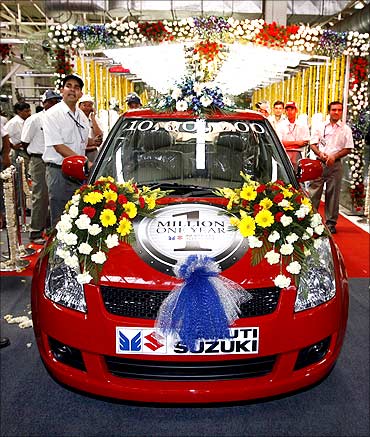 Maruti's millionth baby of the year, a dazzling red Swift.