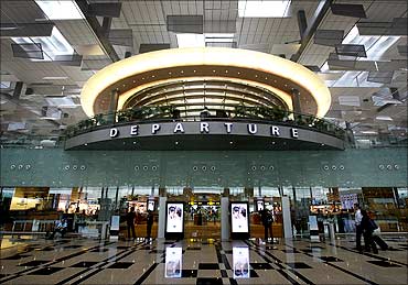 Passengers walk towards their departure gates in Terminal 3 at Singapore's Changi Airport.