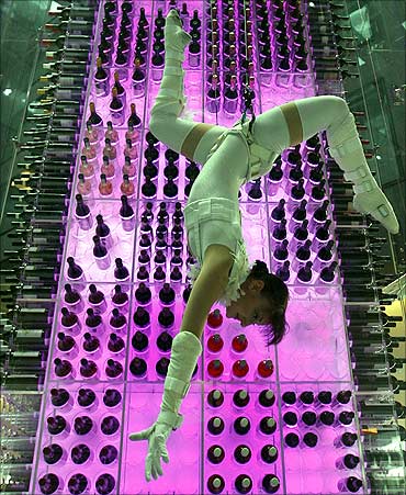 A so-called wine angel poses as she is suspended by steel ropes at a hotel in Zurich Airport.
