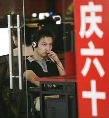A man uses a computer at an internet cafe in Beijing.