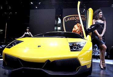 A model poses beside a Lamborghini Murcielago LP 670-4 Superveloce car.