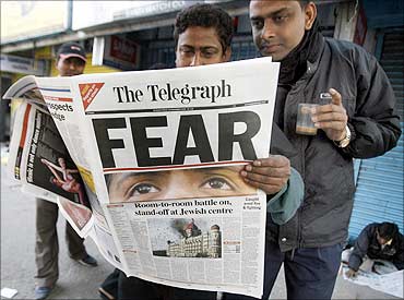 People reading  The Telegrpah newspaper.