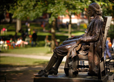 The statue of John Harvard sits in Harvard Yard at Harvard University in Cambridge, Massachusetts.