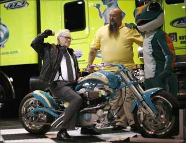 Billionaire financier and Berkshire Hathaway chief executive Warren Buffett poses on a motorcycle during the Berkshire Hathaway Annual Shareholders meeting in Omaha, Nebraska.