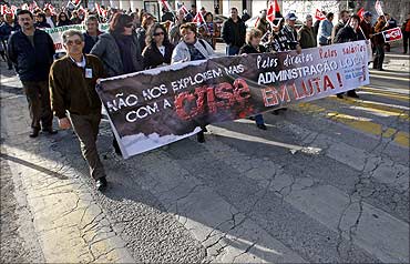 Portuguese workers hold a banner, 'Don't explore us more with crisis'.