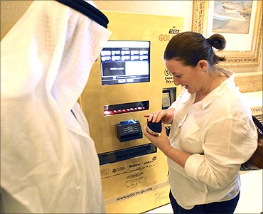 Customers use a gold-plated ATM machine.