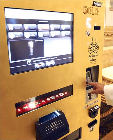 A man uses the ATM at the Emirates Palace Hotel in Abu Dhabi.
