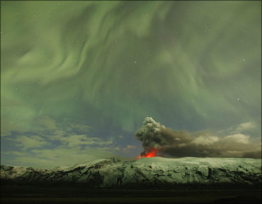 The Northern Lights are seen above the ash plume of Iceland's Eyjafjallajokull volcano.