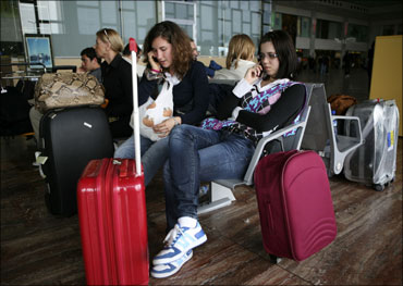 People wait at the Prat Airport in Barcelona. Fifteen airports in Spain were closed.