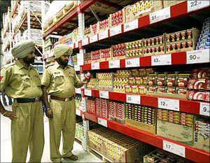Image: Policemen stand inside the first cash-and-carry Wal-Mart store during its inauguration ceremony in Amritsar. Photograph: Munish Sharma/Reuters 