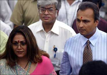 Anil Ambani and his wife Tina (L) enter the campus of group company Reliance Infocomm.