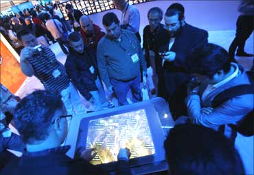 Visitors interact with Bing Maps at the Microsoft booth during the 2010 International Consumer Electronics Show in Las Vegas January 7, 2010.