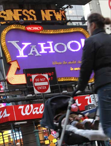 A woman walks in front of a Yahoo! billboard in New York's Time's Square January 25, 2010.