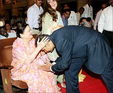 Anil Ambani seeks the blessings of his mother, Kokilaben. Also seen in the picture is Anil's wife Tina Ambani.
