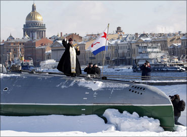 A priest sanctifies a C189 submarine, the first Russian private submarine museum, in St. Petersburg.