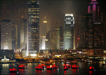 Illuminated boats float on Hong Kong's Victoria Harbour.