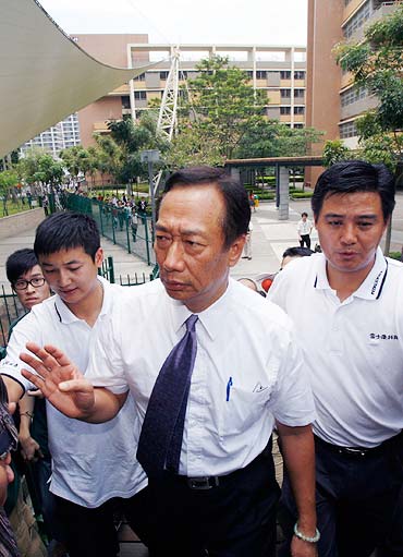 Taiwanese tycoon Terry Gou, founder of Foxconn, visits a residential area of a Foxconn factory.
