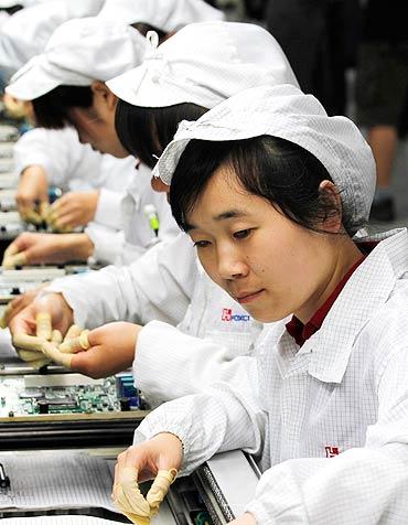 Workers are seen inside a Foxconn factory in the township of Longhua in Guangdong.