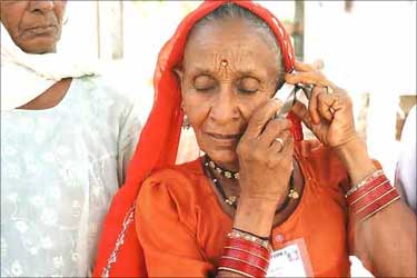 A rural woman talking on her phone.