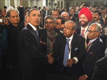 Barack Obama meets members of the audience after delivering his speech.