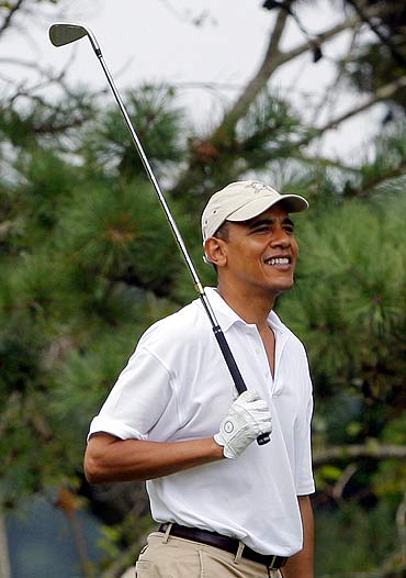 Barack Obama playing golf.