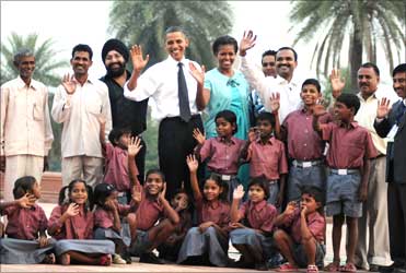The Obamas with the school children of traditional artisans who carried out renovation works at Humayun Tomb.