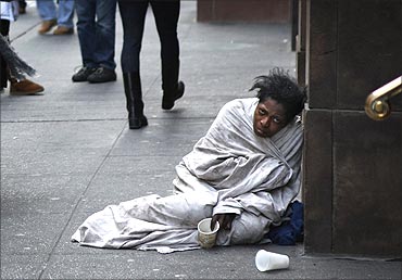 A panhandler begs for money on Fifth Avenue in New York.
