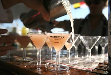 A bartender pours martinis on a yacht at the United States Sailboat Show in Annapolis, Maryland.