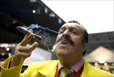 A man smokes a cigar during the opening night of the Millionaire Fair in Moscow.