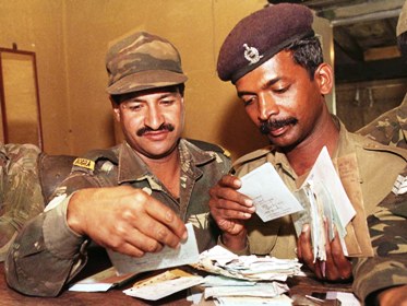 Indian soldiers search for their letters at a field post office in Kargil.