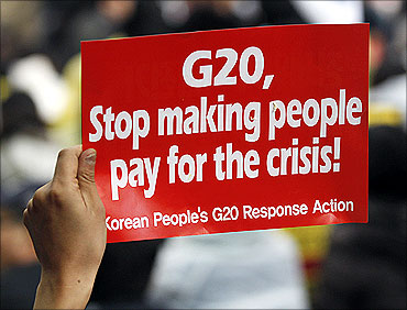 A demonstrator holds up a sign during an anti G20 protest in downtown Seoul.