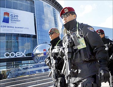 Armed policemen patrol outside a venue of the G20 Seoul Summit in Seoul.